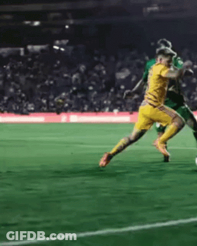 Soccer Player In Yellow Jersey Kicking Ball GIF