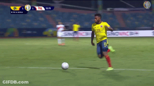 Soccer Player In Yellow Jersey Number 19 Kicking Ball GIF