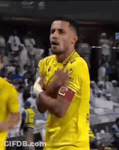 Soccer Player In Yellow Jersey With Hands In Pockets GIF