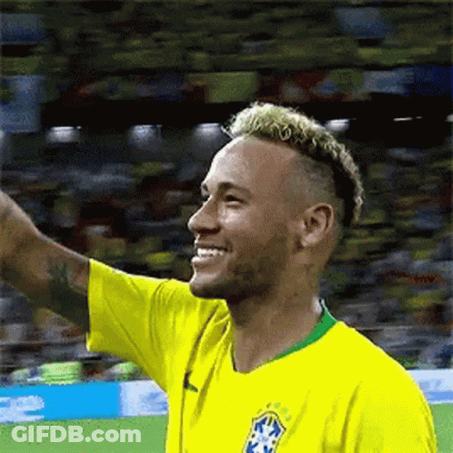 Soccer Player In Yellow Shirt Waving Smile GIF