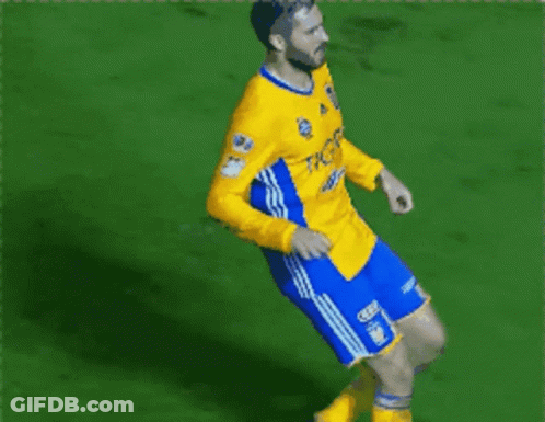 Soccer Player Jumping In Yellow And Blue Jersey GIF