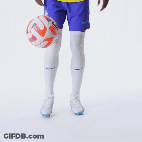 Soccer Player Kicking Ball In Blue Shorts And White Socks GIF