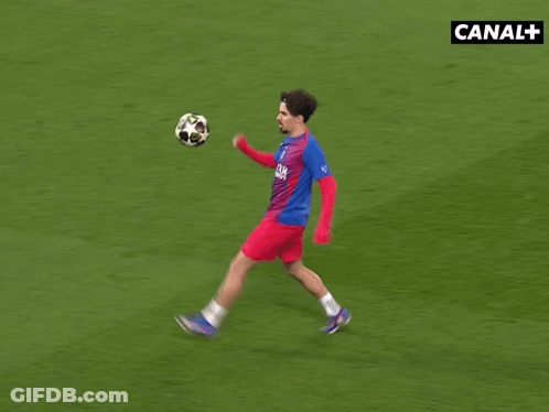 Soccer Player Kicking Ball In Front Of Canal+ Sign GIF