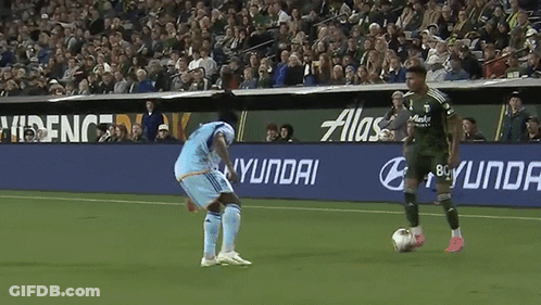 Soccer Player Kicking Ball In Front Of Hyundai Sign GIF