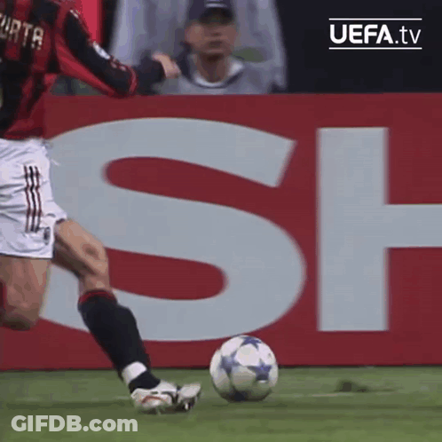 Soccer Player Kicking Ball In Front Of UEFA.tv Sign GIF