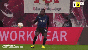 Soccer Player Kicking Ball In Front Of Workwear Sign GIF