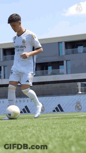 Soccer Player Kicking Ball On Field With Building GIF