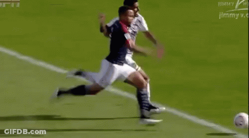 Soccer Player Kicking Ball Opponent Trying To Stop GIF