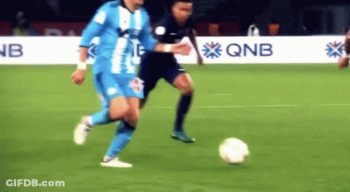 Soccer Player Kicking Ball With QNB In Background GIF