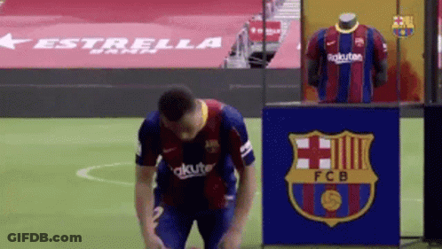 Soccer Player Kneeling In Front Of FCB Sign GIF