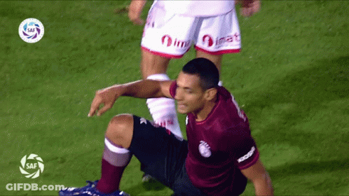 Soccer Player Kneeling In Maroon Shirt GIF