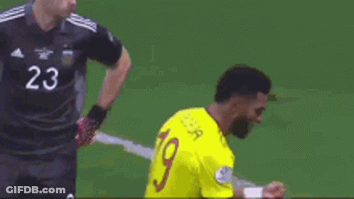 Soccer Player Kneeling In Yellow Jersey Number 19 GIF