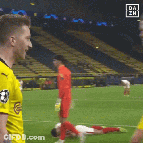 Soccer Player Laying Talking To Another With Onlooker GIF