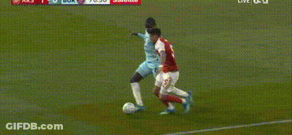 Soccer Player Lying As Another Kicks Ball GIF
