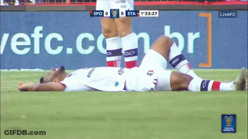 Soccer Player Lying On Field With Live FC Advertisement GIF