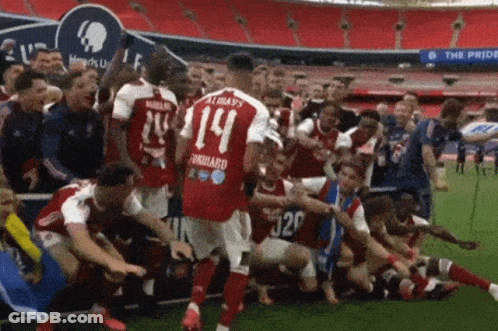 Soccer Player Number 14 Surrounded By Teammates GIF