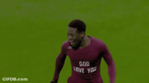 Soccer Player Number 18 Hugged By Teammates GIF