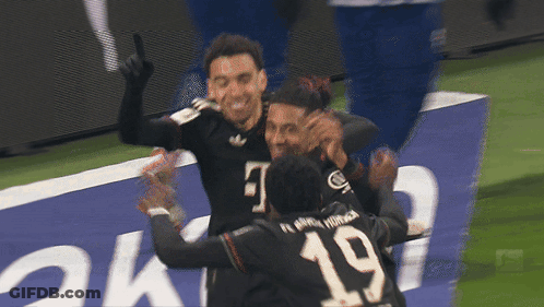 Soccer Player Number 19 Hugging Another Player GIF