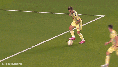 Soccer Player Number 25 Jumping To Catch Ball GIF