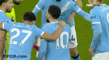 Soccer Player Number 27 Surrounded By Teammates GIF