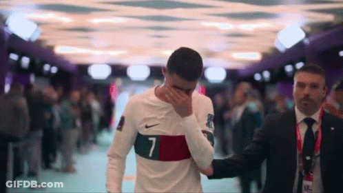 Soccer Player Number 7 Helped By Man In Suit GIF