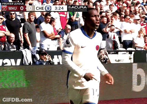 Soccer Player On Field With Premier League Scoreboard GIF