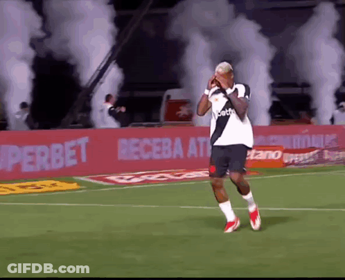 Soccer Player On Field With Smoke In Stands GIF