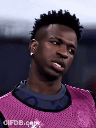 Soccer Player Purple Vest And Earrings Looking Sideways GIF