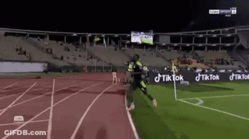 Soccer Player Running On Stadium Track GIF