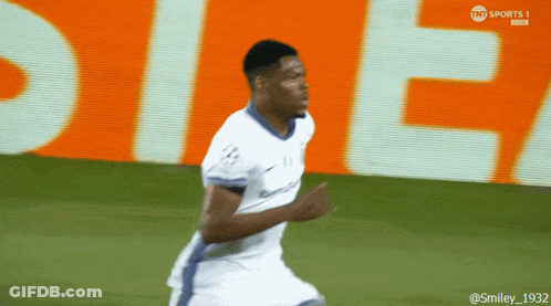 Soccer Player Running Past Orange TNT Sports Sign GIF