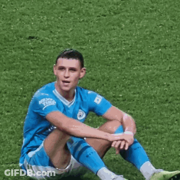 Soccer Player Sitting Cross-Legged On Grass GIF