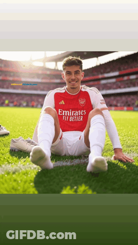 Soccer Player Sitting On Grass In Red Jersey GIF