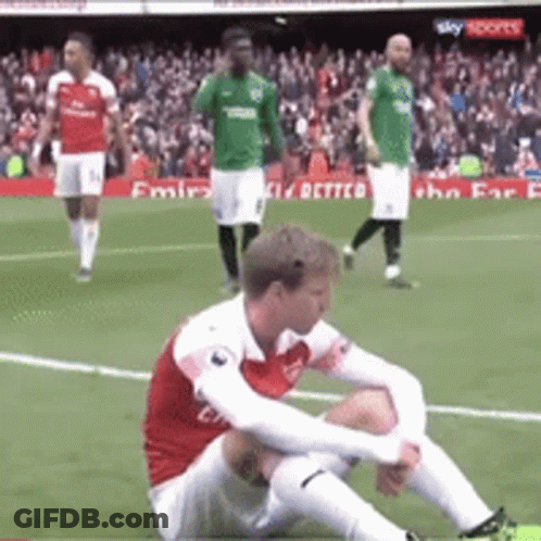 Soccer Player Sitting On Ground During Match GIF