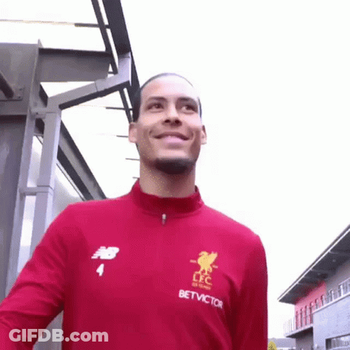 Soccer Player Smiling At Camera In Red Jacket GIF