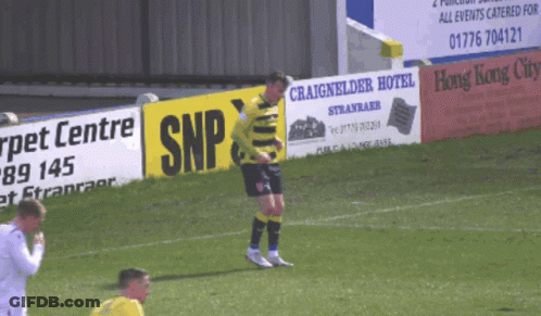 Soccer Player Standing In Front Of Sign Saying SNP GIF