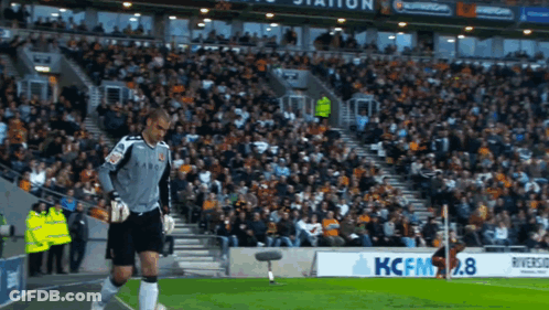 Soccer Player Standing Next To Kcfm2.8 Sign GIF
