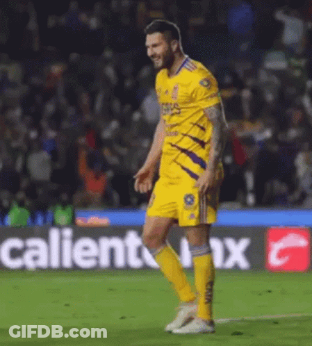 Soccer Player Walking Past Caliente Advertisement GIF