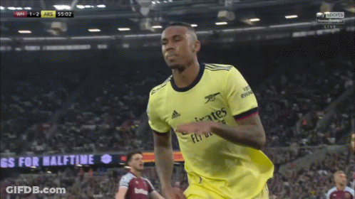 Soccer Player Wearing A Yellow Jersey That Says Emirates Fly Better On It GIF