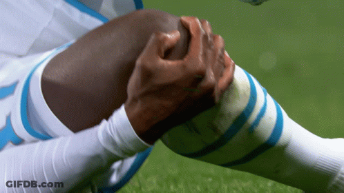 Soccer Player With Blue White Socks Holding Knee GIF