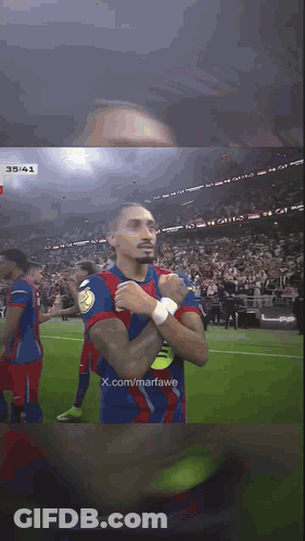 Soccer Player With Hands Folded In Front Of Crowd GIF