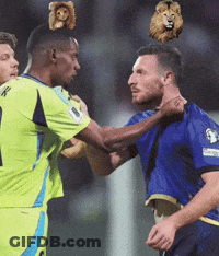 Soccer Player With Stuffed Animal On Head Being Tackled GIF