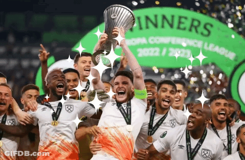 Soccer Players Celebrate With Trophy In Front Of Winners Banner GIF