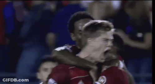 Soccer Players Celebrating Goal In Red GIF