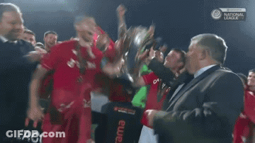 Soccer Players Celebrating With Trophy GIF