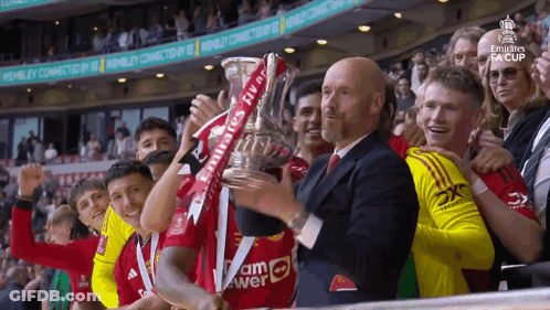 Soccer Players Holding Emirates Trophy GIF