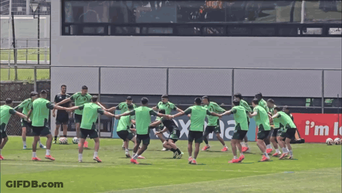 Soccer Players Holding Hands In Front Of Rex Sign GIF