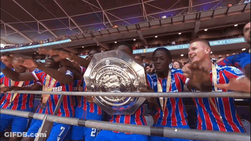 Soccer Players Holding Trophy At Wembley GIF