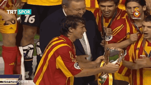 Soccer Players Holding Trophy Number 16 GIF