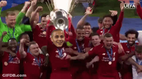 Soccer Players Holding Trophy With Mask GIF