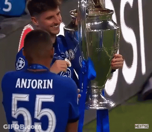 Soccer Players Holding Trophy GIF